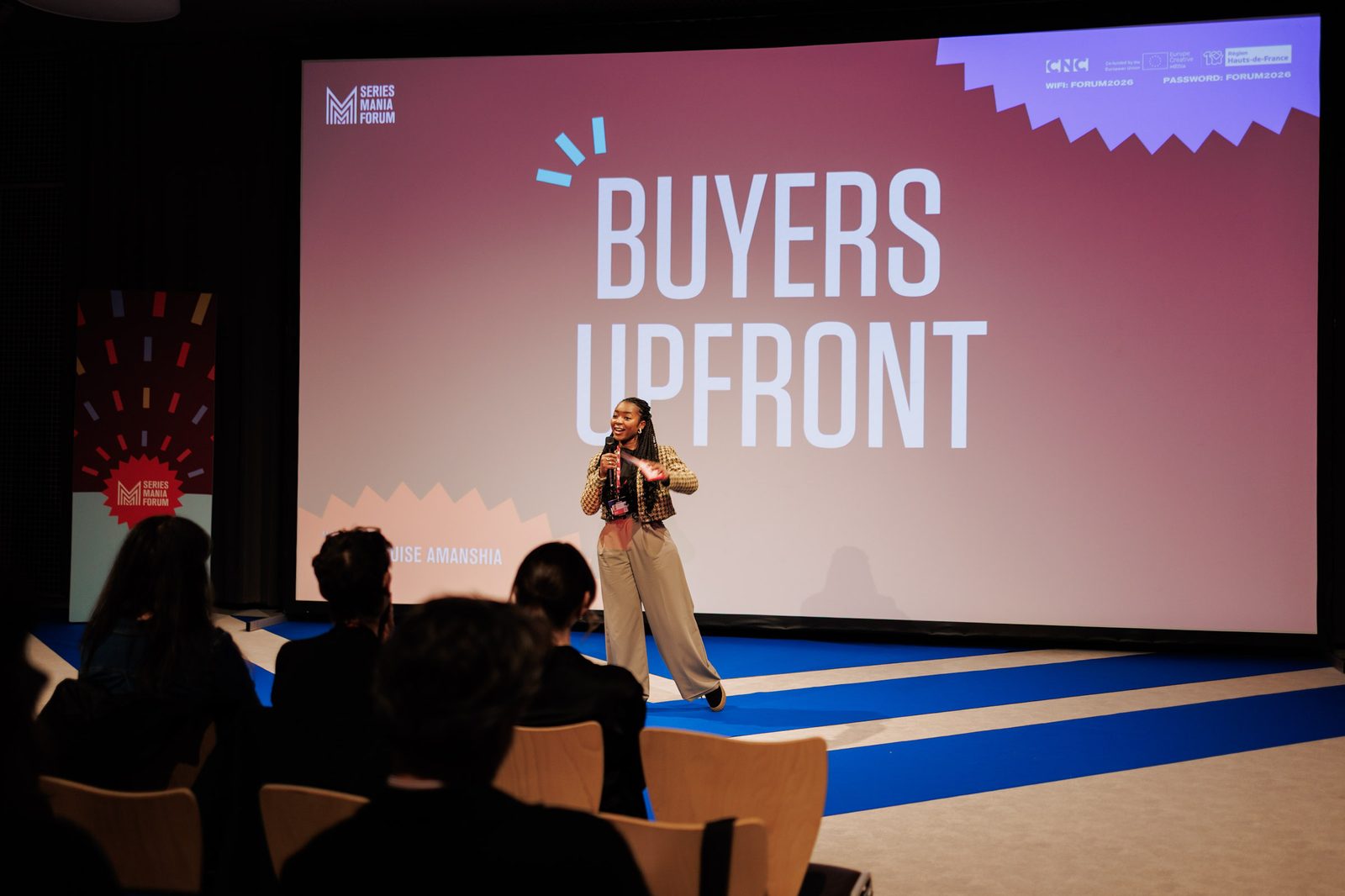 Emma-Louise Amanshia hosting on stage at Series Mania