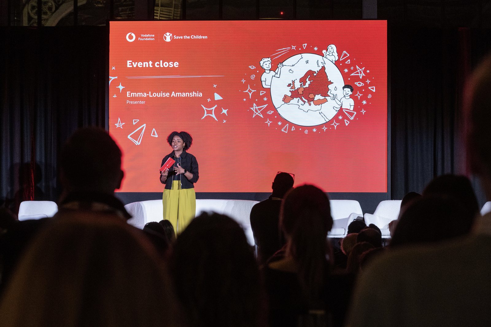 Emma-Louise Amanshia presenting at a Vodafone Foundation and Save the Children event
