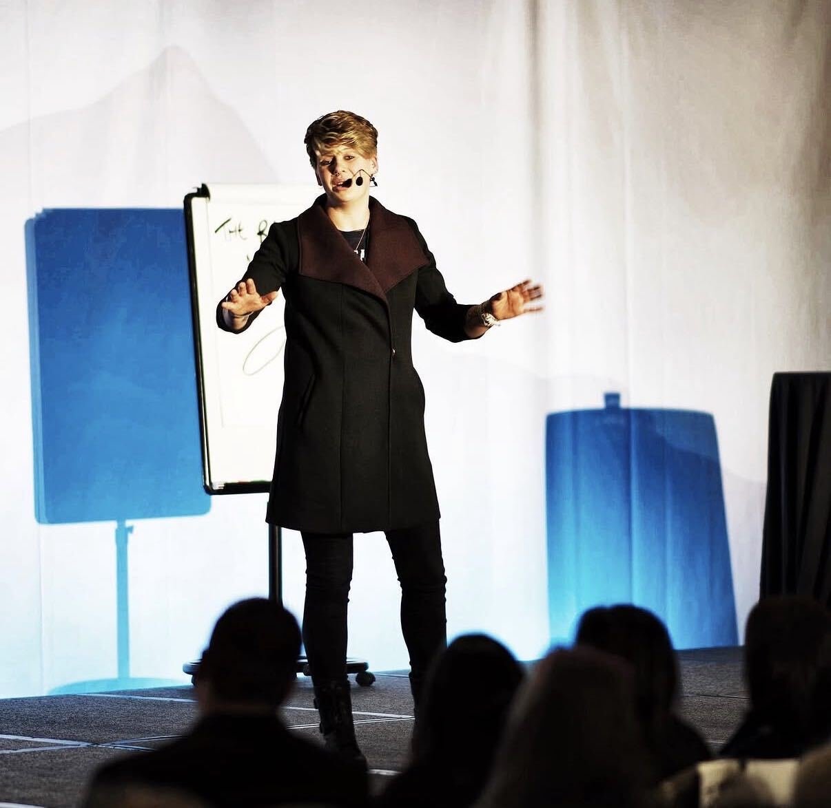 Presenter delivering training on stage at the I Am Creator event