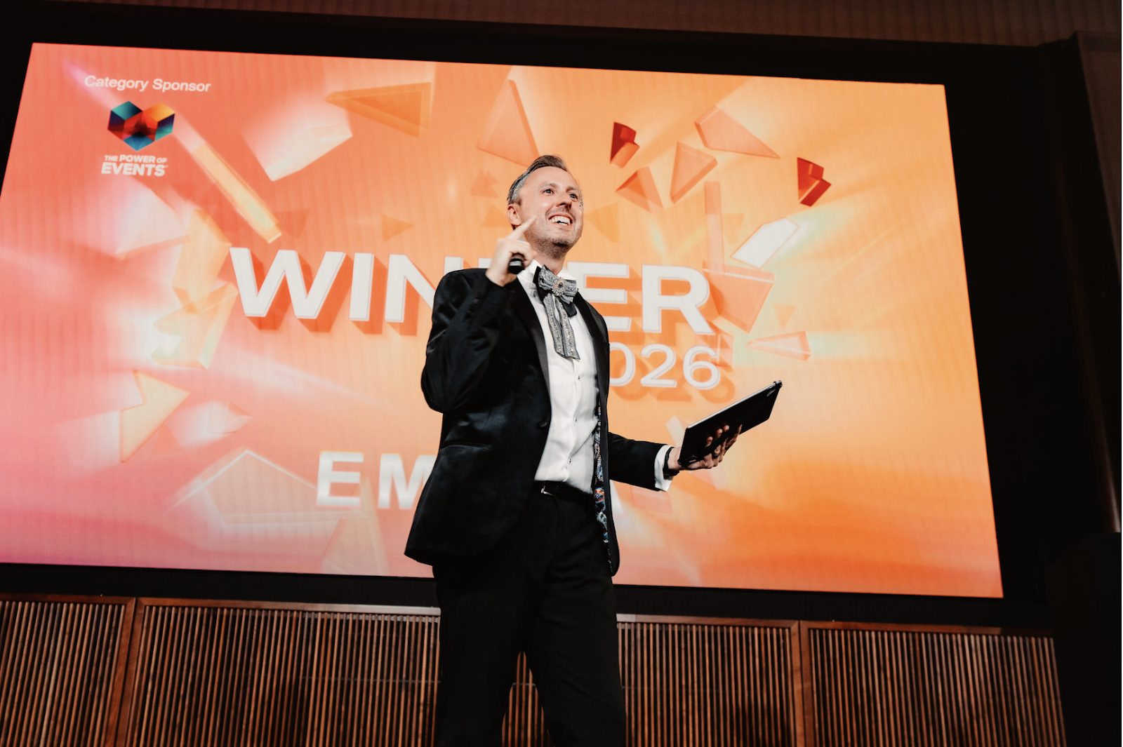 Jamie Body presenting a winner announcement on stage