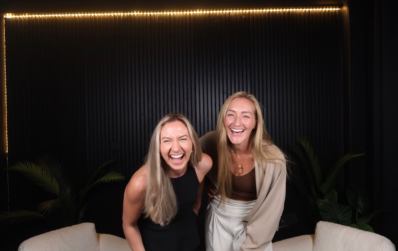 Latasha Arnone laughing with a guest on her podcast