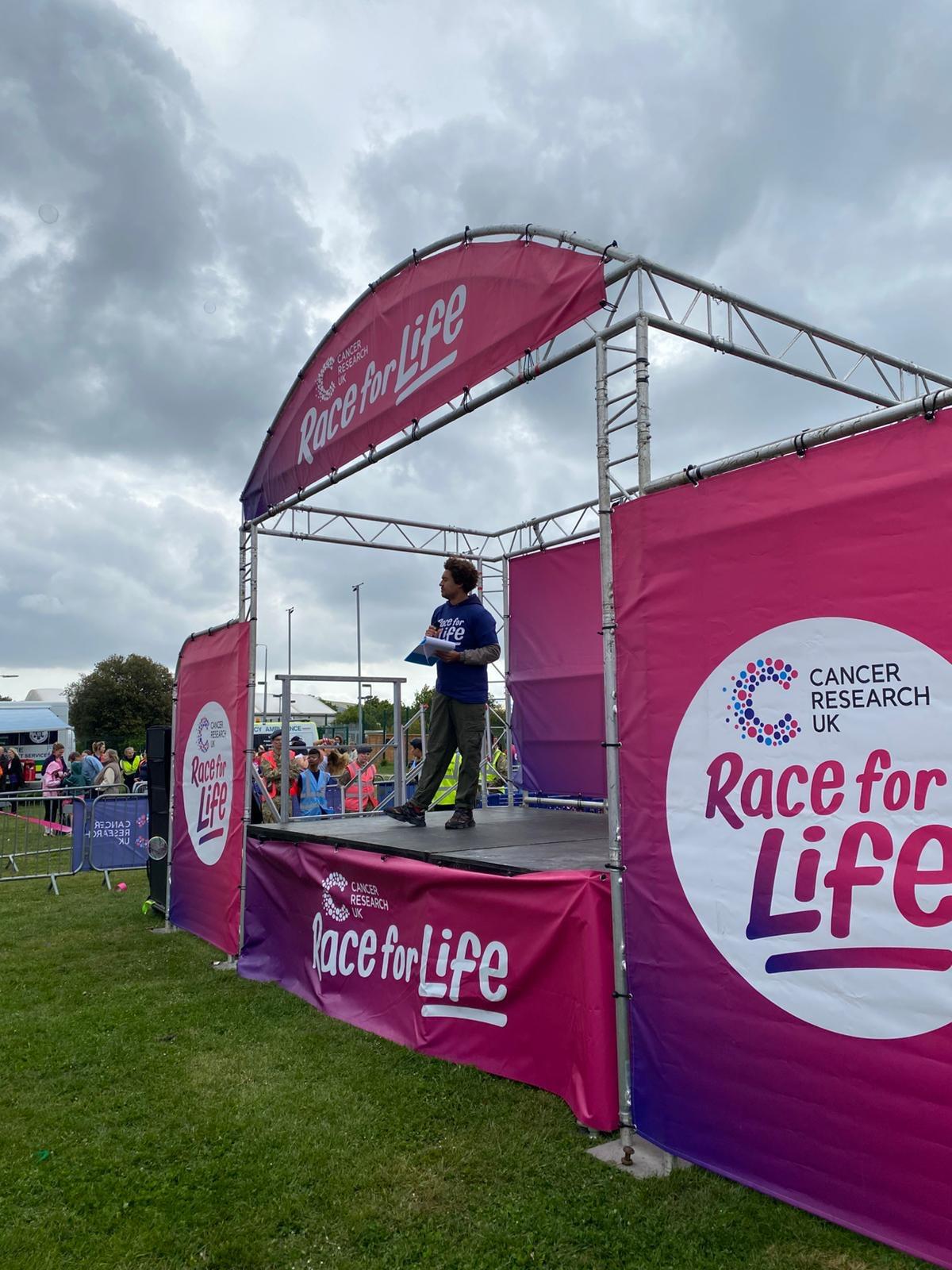 Ollie Pittam hosting on the start line at a Cancer Research UK Race for Life event