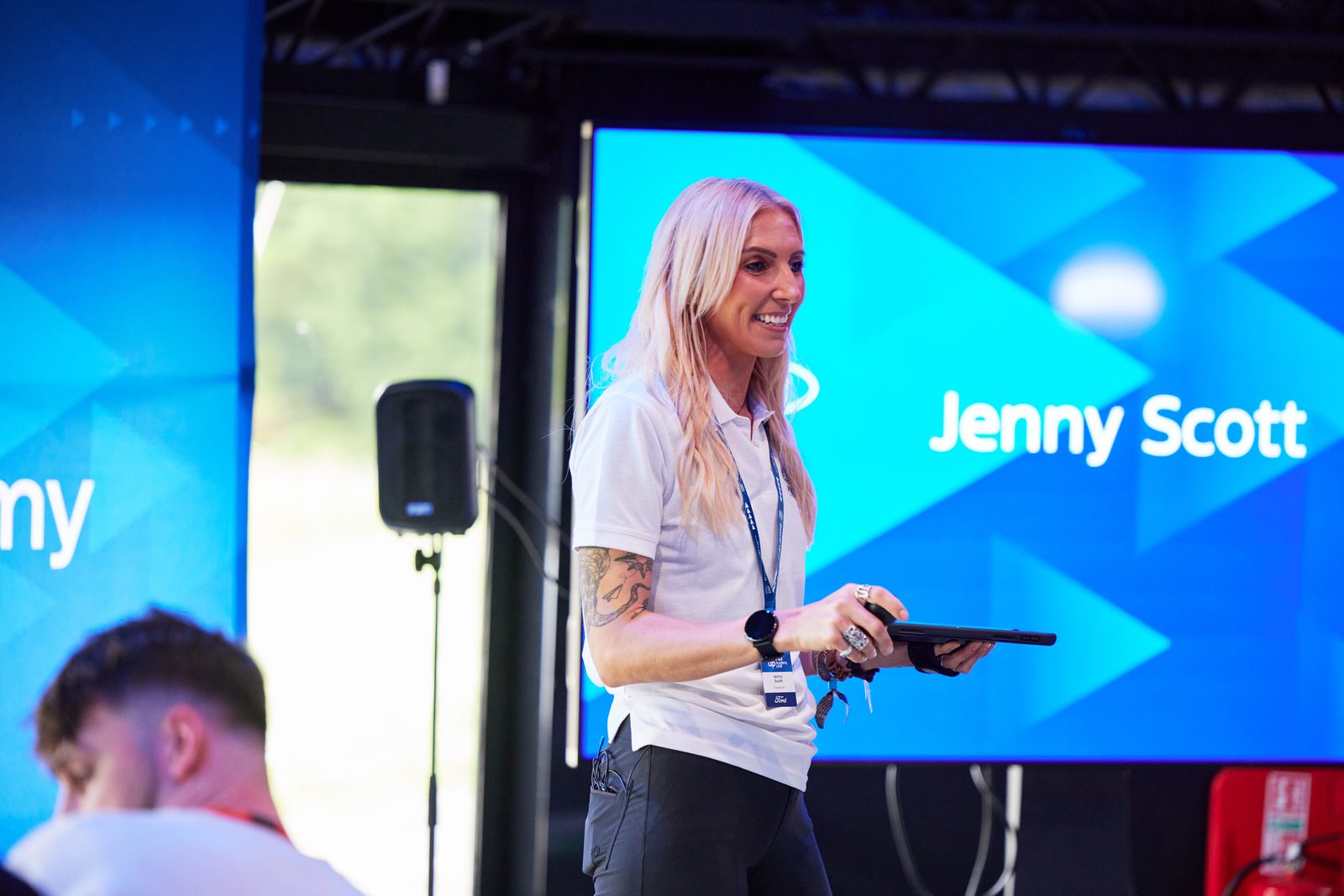 Presenter delivering training on stage at the Ford Power Up Academy