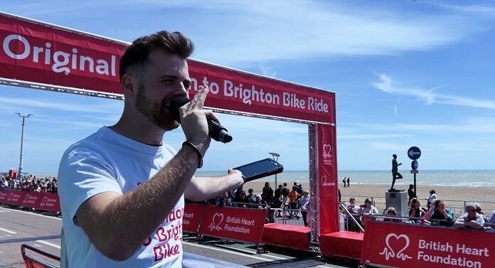 Rob Thornton hosting the finish line at the London to Brighton Bike Ride for the British Heart Foundation