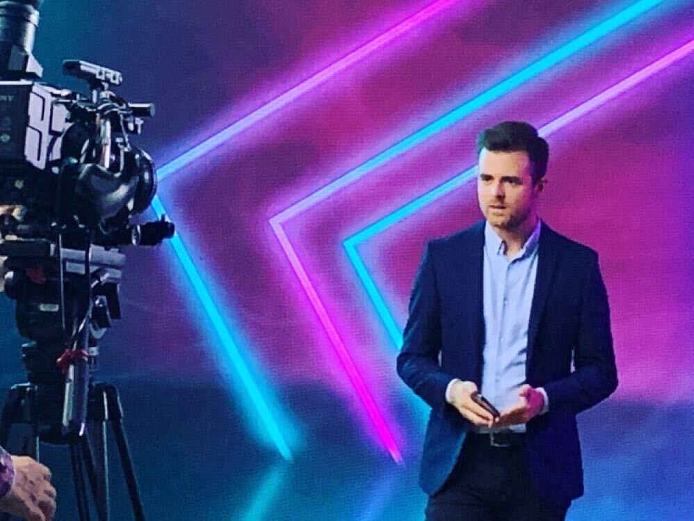 Rob Thornton presenting on stage at a corporate brand event