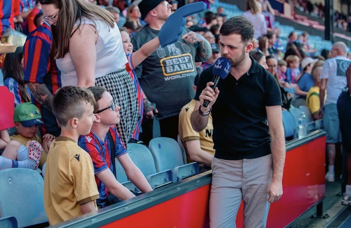 Rob Thornton interviewing young fans in the stands at Crystal Palace FC