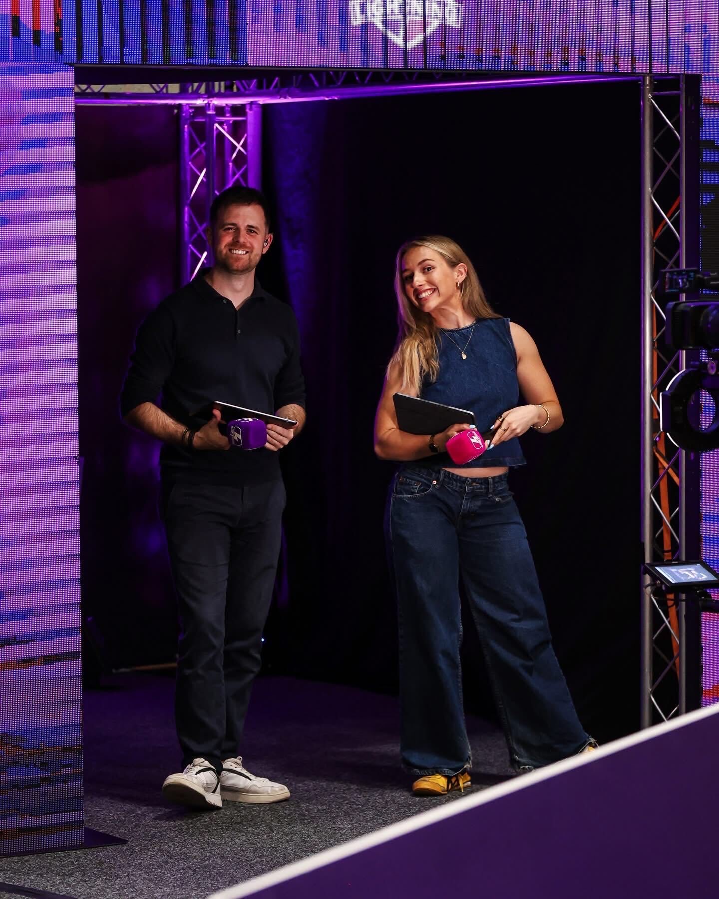 Two presenters hosting together on stage
