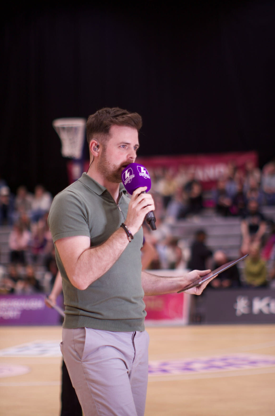 Rob Thornton commentating courtside at a Netball Super League match