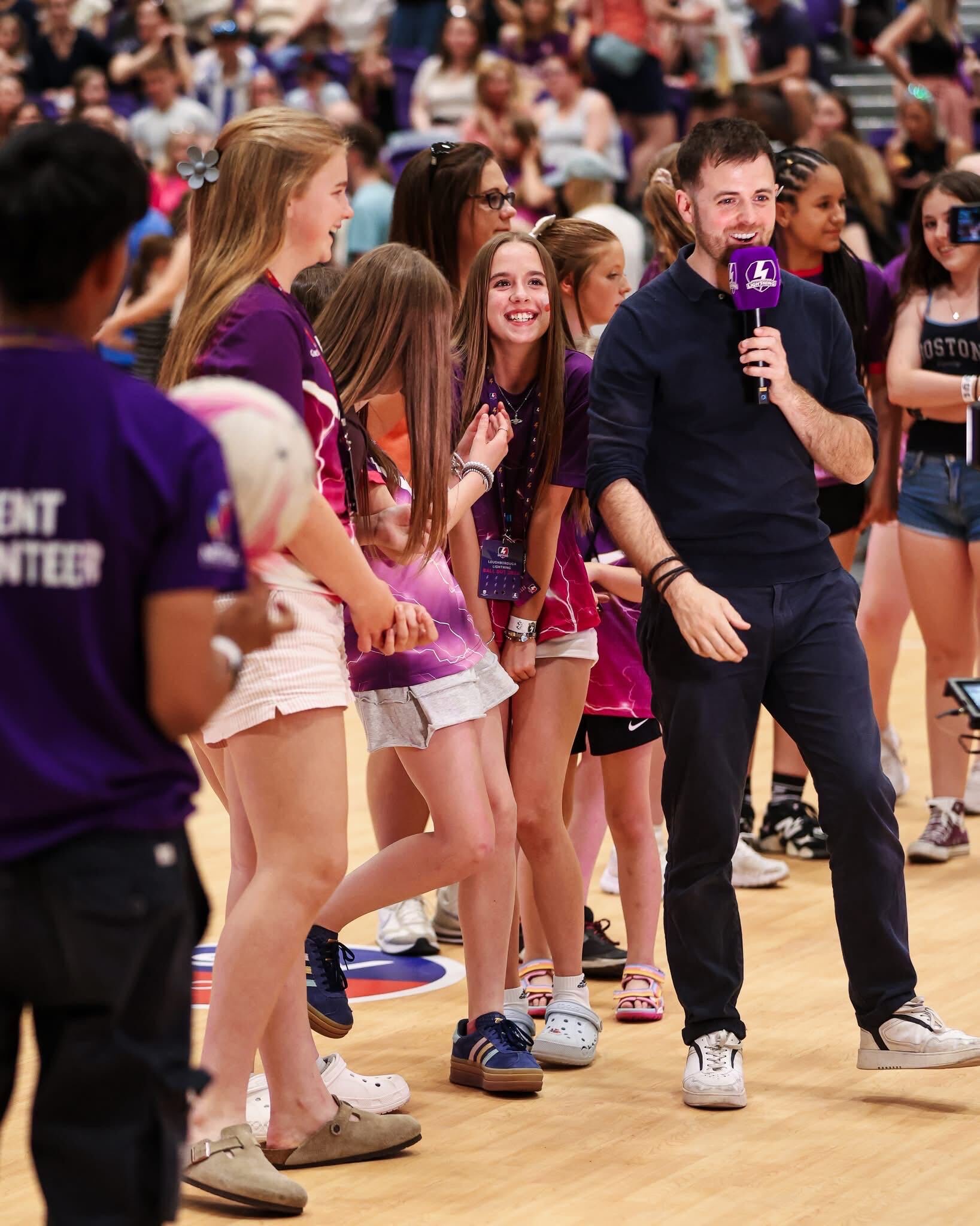 Rob Thornton with young fans courtside at a Loughborough Lightning netball match